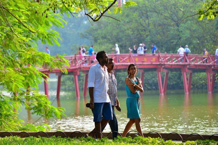 Tourists walk around Hoan Kiem Lake